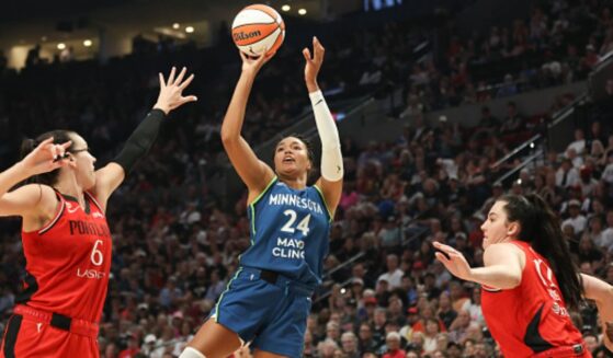 Napheesa Collier shoots a basketball as players surround her on the court in Portland, Oregon on August 12, 2026.