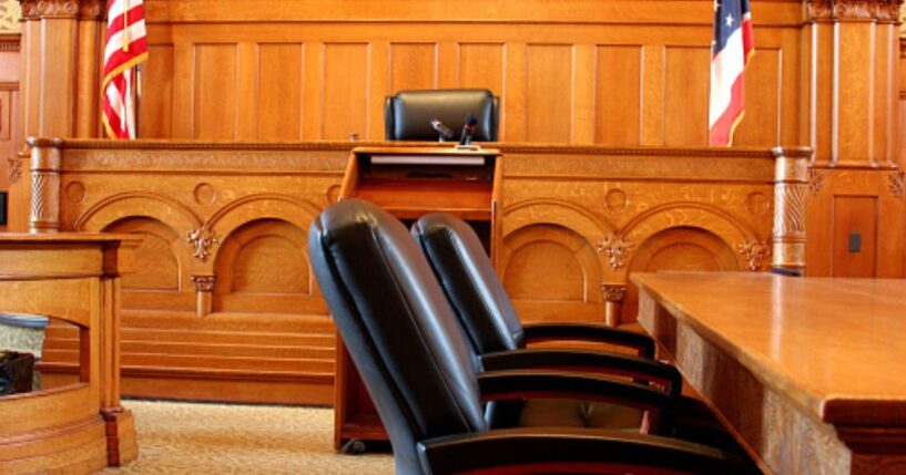 An empty American courtroom is illuminated by light.