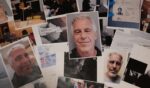 Pictures of Epstein are scrambled upon a wooden table.