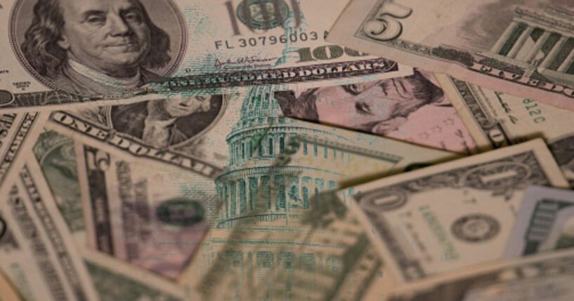 Dollar bills are pictured with an overlay of the United States Capitol Building.