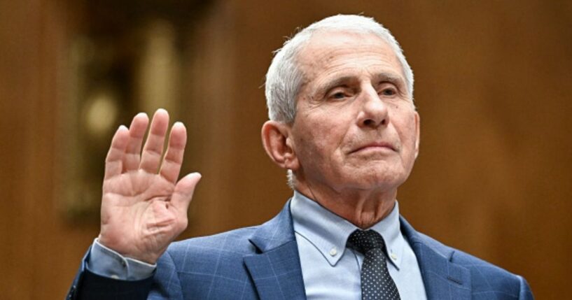 Anthony Fauci stands with his right hand in the air as he takes the oath before entering a hearing for the Senate Homeland Security Committee on July 29, 2026.