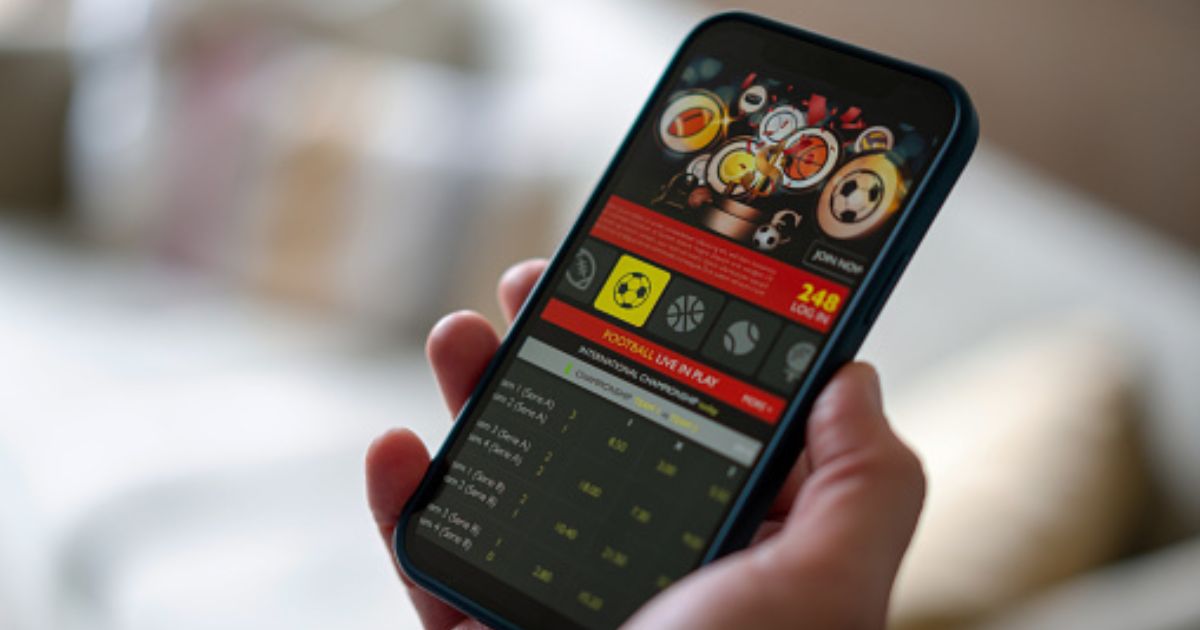 A phone screen is displayed with a gambling app on the interface.