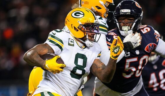 Josh Jacobs #8 of the Green Bay Packers runs the ball during an NFC Wild Card Playoff game against the Chicago Bears at Soldier Field on Jan. 10 in Chicago, Illinois.
