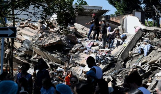 Locals work to clear out a collapsed building after an earthquake hits Cali, Colombia on Aug. 10, 2026.