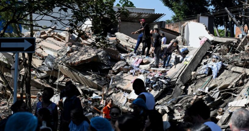 Locals work to clear out a collapsed building after an earthquake hits Cali, Colombia on Aug. 10, 2026.