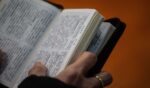 A Christian worshipper holds a Bible while attending a church service in Hong Kong on Dec. 23, 2018.