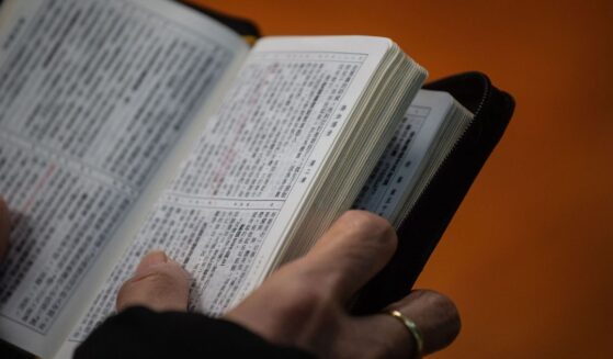 A Christian worshipper holds a Bible while attending a church service in Hong Kong on Dec. 23, 2018.