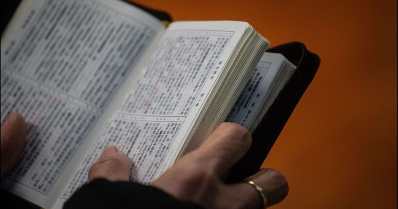 A Christian worshipper holds a Bible while attending a church service in Hong Kong on Dec. 23, 2018.