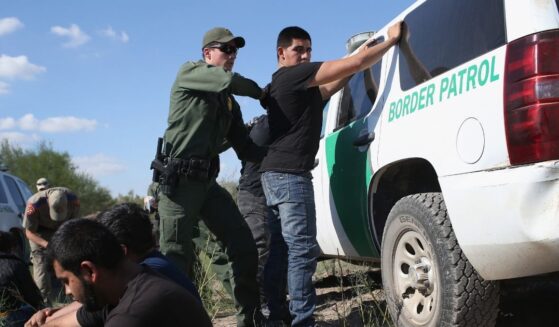A U.S. Border Patrol officer searches an illegal immigrant near the U.S.-Mexico border on Dec. 7, 2015 in Rio Grande City, Texas.