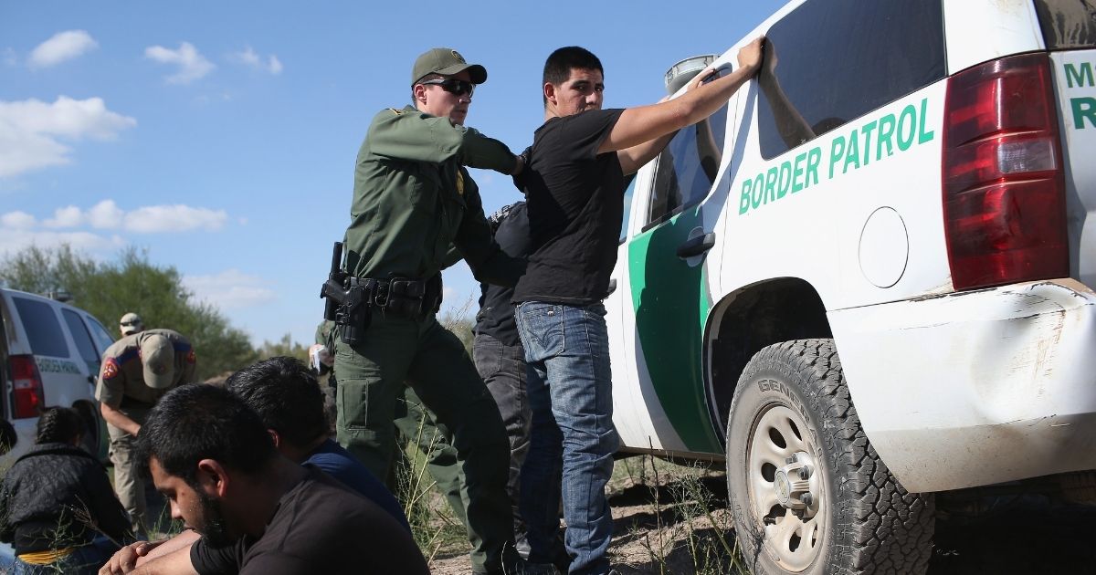 A U.S. Border Patrol officer searches an illegal immigrant near the U.S.-Mexico border on Dec. 7, 2015 in Rio Grande City, Texas.