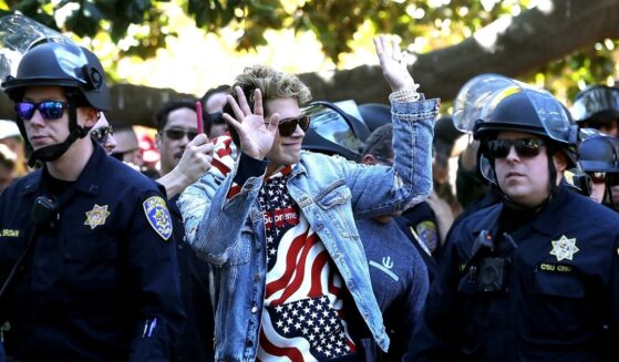 Right-wing commentator Milo Yiannopoulos is escorted by police officers after appearing at a free-speech rally at U.C. Berkeley on Sept. 24, 2017, in Berkeley, California.