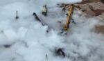 Clouds of gas spewed out of a work site after an unoccupied semi truck reportedly rolled into the pipeline, damaging it.