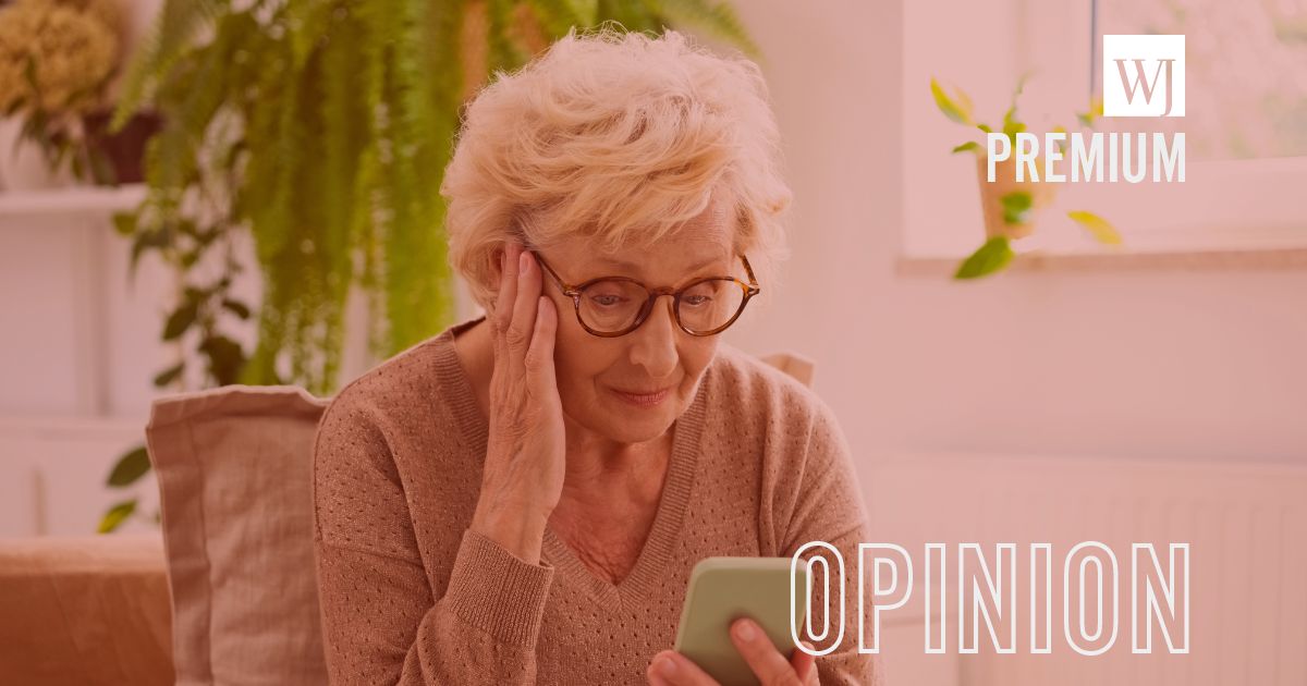 A senior woman wearing casual brown clothes sitting on a sofa at home and using a mobile phone.