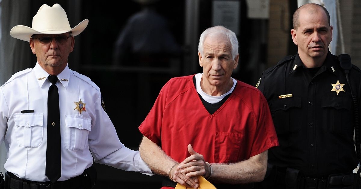 Former Penn State assistant football coach Jerry Sandusky leaves the Centre County Courthouse after being sentenced in his child sex abuse case on Oct. 9, 2012, in Bellefonte, Pennsylvania.