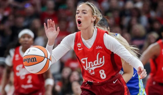 Sophie Cunningham #8 of the Indiana Fever reaches for the ball during the first half Friday against the Dallas Wings at Gainbridge Fieldhouse in Indianapolis, Indiana.
