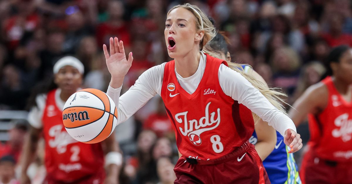 Sophie Cunningham #8 of the Indiana Fever reaches for the ball during the first half Friday against the Dallas Wings at Gainbridge Fieldhouse in Indianapolis, Indiana.