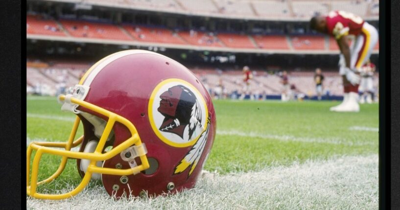 A Washington Redskins helmet lies on the field Nov. 21, 1993, during a game against the Los Angeles Rams at Anaheim Stadium in Anaheim, California. The Rams won the game, 10-6.