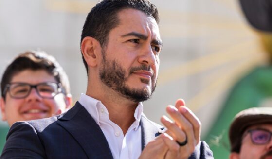 Michigan Democratic Senate primary winner Abdul El-Sayed claps during a news conference Wednesday after his victory over Rep. Haley Stevens.