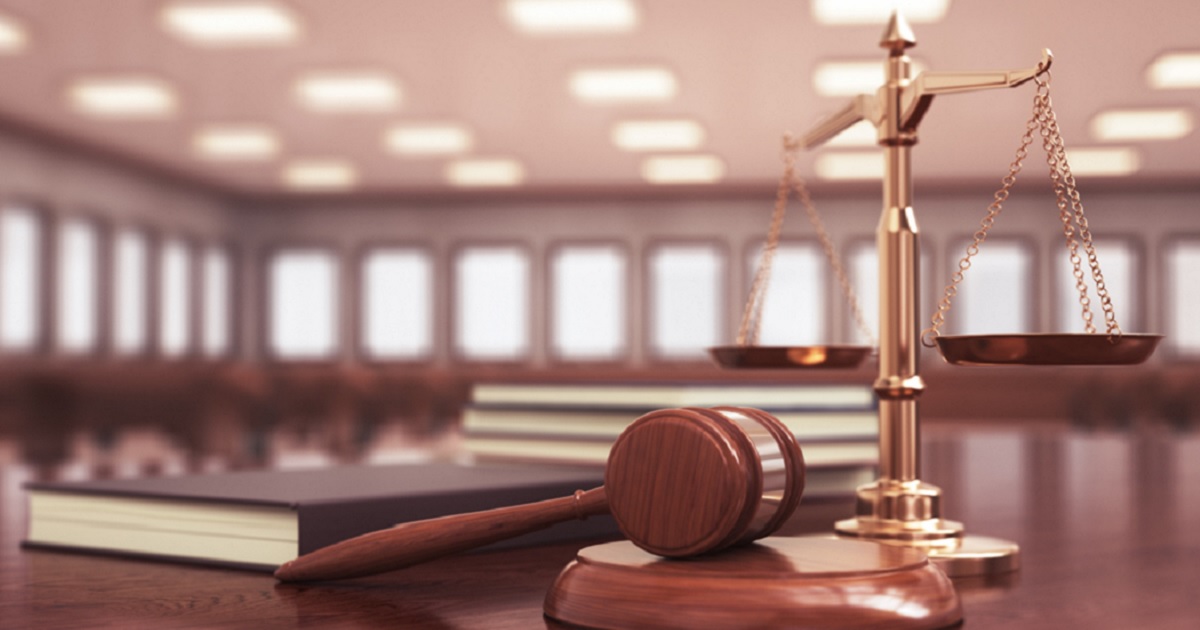 A judge's gavel in an empty courtroom.