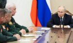 Russian President Vladimir Putin meets with Russian Defense Ministry leadership Wednesday in a photo distributed by the Russian state agency Sputnik.