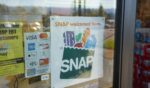 A "SNAP Welcomed Here" sign is seen at the entrance to a Big Lots store in Portland, Oregon, on Oct. 28, 2020.