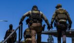 Immigration and Customs Enforcement agents walk outside the Ventura County Government Center in Ventura, California, on July 27, 2026.