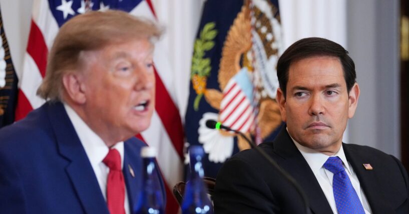 Secretary of State Marco Rubio listens as President Donald Trump speaks during a roundtable on the American mining industry at the Department of State on Aug. 7, 2026, in Washington, D.C.