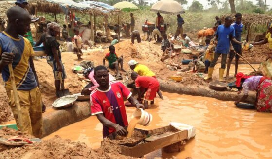 In this photograph taken on April 4, 2018, gold miners work at a mining site in the Cameroon town of Betare Oya.