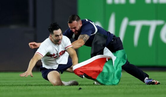 A fan carrying a Palestinian flag runs onto the field at 9:11 p.m. in the middle of the seventh inning at Yankee Stadium on Sept. 11, 2026, in the Bronx borough of New York City.
