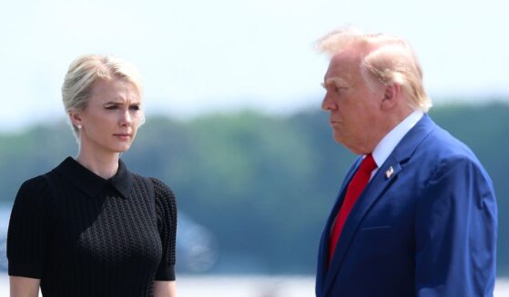 Secretary of War Pete Hegseth, executive assistant to President Donald Trump Natalie Harp, and President Donald Trump attend a dignified transfer at Dover Air Force Base on July 22, 2026, in Dover, Delaware.