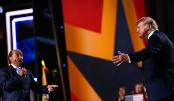 Musician Lee Greenwood greets President Donald Trump as he takes the stage to speak on the second day of the 2026 Republican National Convention at the American Airlines Center on Sept. 10, 2026, in Dallas, Texas.