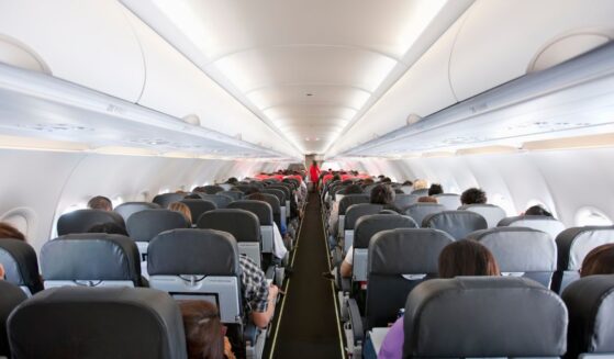 Passengers inside the cabin of a commercial airliner during flight.