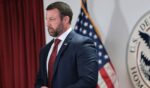Secretary of Homeland Security Markwayne Mullin stands silently during a press conference at the US Citizenship and Immigration Services field office on Sept. 1, 2026, in New York City.