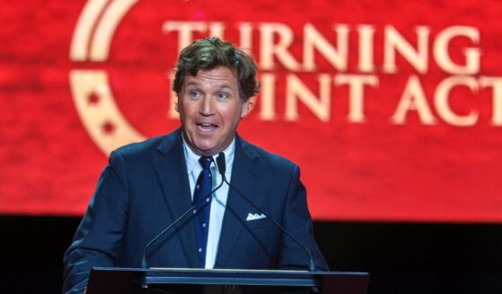 Political commentator Tucker Carlson speaks during the memorial service for political activist Charlie Kirk at State Farm Stadium on Sept. 21, 2025, in Glendale, Arizona.