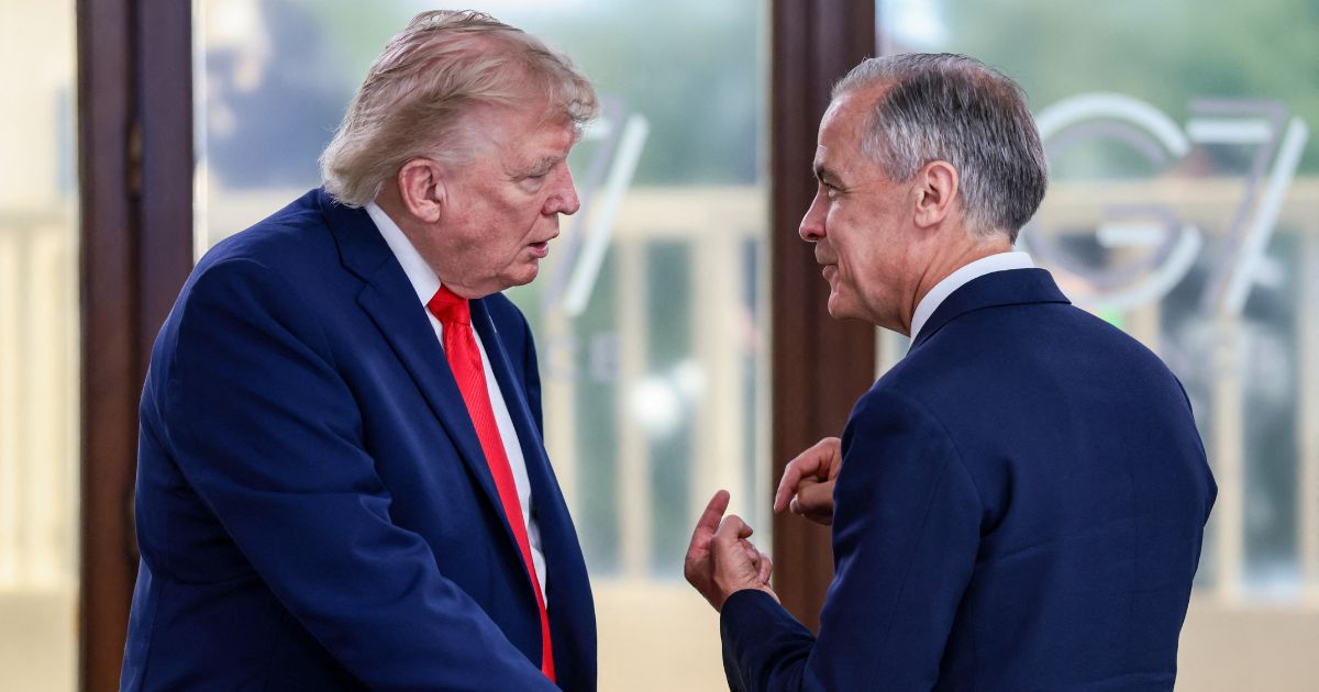 President Donald Trump speaks with Canadian Prime Minister Mark Carney during a work lunch as part of the G7 summit, in Evian, eastern France, on June 16, 2026.