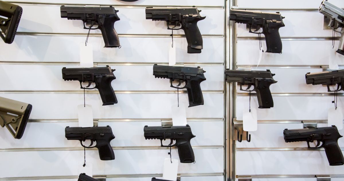 A gun wall rack with pistols.