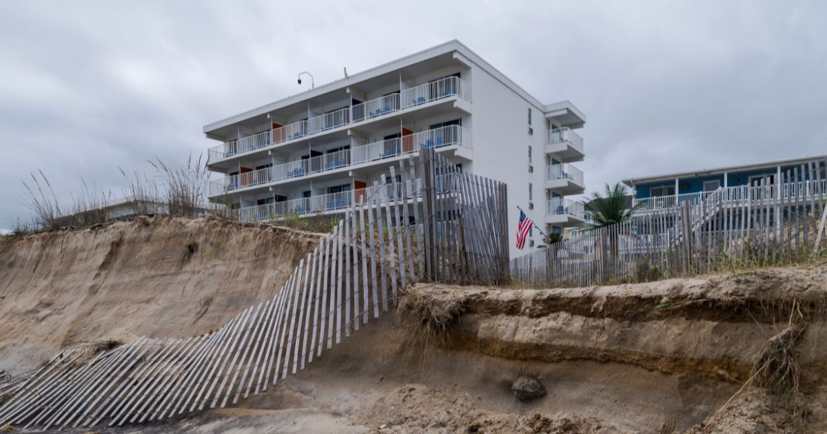 Fences and sand dunes lay in ruin along Ocean City Beach on Sept. 28, 2026, in Ocean City, Maryland.