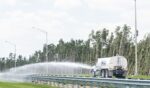 A truck spraying water on a highway near Miami, Florida, on April 30, 2018.