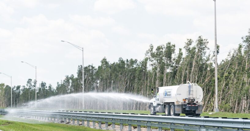 A truck spraying water on a highway near Miami, Florida, on April 30, 2018.