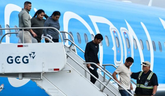Migrants deported from the United States get off an airliner at the runway of the Juan Santamaria International Airport in Alajuela, Costa Rica, on April 11.