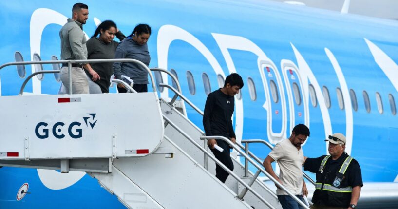 Migrants deported from the United States get off an airliner at the runway of the Juan Santamaria International Airport in Alajuela, Costa Rica, on April 11.