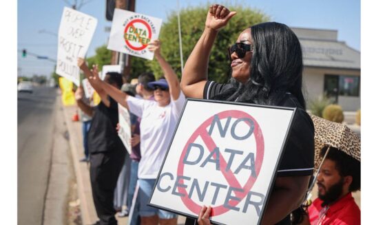 Protesters in Imperial, California, wave signs during a nationwide protest July 18 against AI data center expansion.