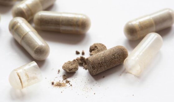 Drug capsules are laid on a table.