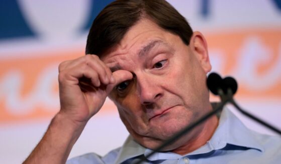 Troy Jackson, Senate candidate in Maine, scratches his face at a rally in Bangor, Maine on July 25, 2026.