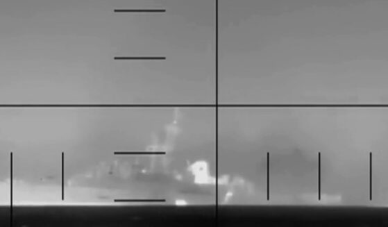 A camera shot of an Iranian frigate, the IRIS Dena, sinking while in flames on March 4, 2026.