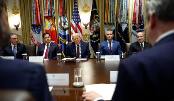 Trump cabinet officials sit on the cabinet room alongside President Trump on August 26, 2025 in the White House.