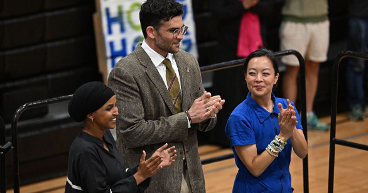 Hasan Piker stands beside Wisconsin Gubernatorial candidate Francesca Hong and Congresswoman Ilhan Omar at a rally in Milwaukee, Wisconsin.