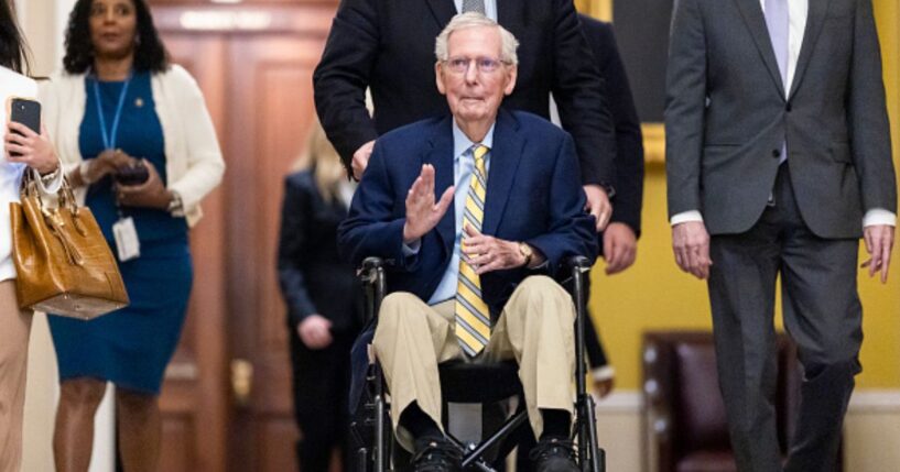 Kentucky Senator Mitch McConnell waves to a crowd in the United States Capitol as he is wheeled in on September 14, 2026.