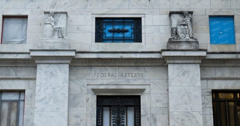 The Federal Reserve building stands in Washington, D.C. under gray skies.