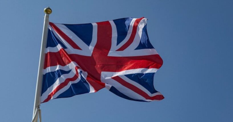 The flag of the United Kingdom waves in the wind on a beach in Northern France on June 18, 2025.